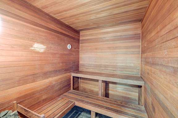 A wooden sauna with a bench and a door at Glen at North Creek, Everett, WA