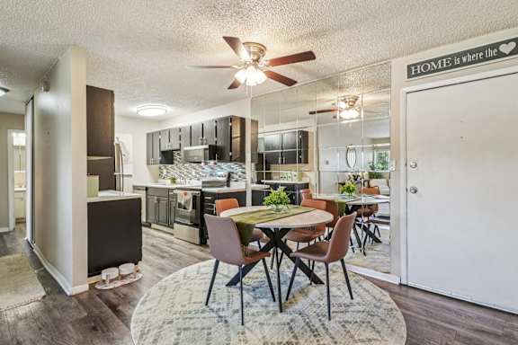 A kitchen with a dining table and chairs in the middle of the room at The Montecito, Colorado Springs