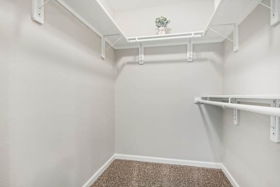 A small room with white walls and a carpeted floor at The Glen at Highpoint, Dallas