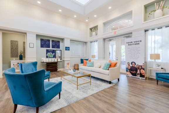 a clubhouse with couches chairs and a coffee table at Heritage Bay, Jensen Beach Florida