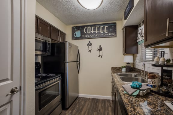Kitchen with stainless steel appliances and a granite counter top at Mountain Run Apartments, New Mexico
