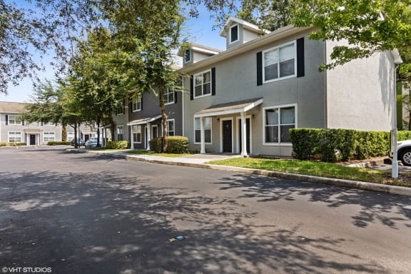 Two story apartment building with parking area at The Arbor Walk Apartments, Tampa