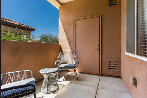 A patio with a table and two chairs. at Broadstone Towne Center, Albuquerque, New Mexico