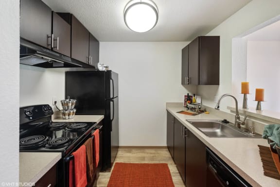 Kitchen with Black Appliances at North Creek Apartments, Everett, WA, 98208