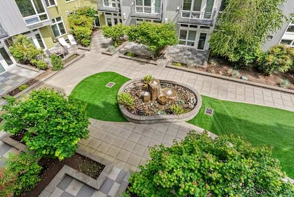 A courtyard with a fountain surrounded by buildings.