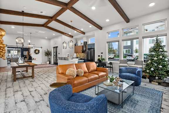 A living room with a blue chair and a brown couch.