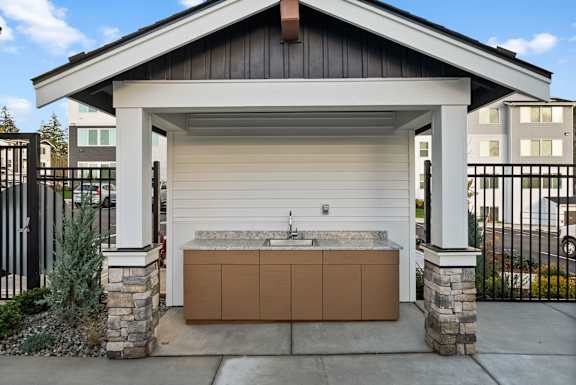 A garage with a brown countertop and a stone pillar.