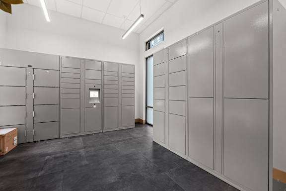 A room with grey lockers and a white ceiling.