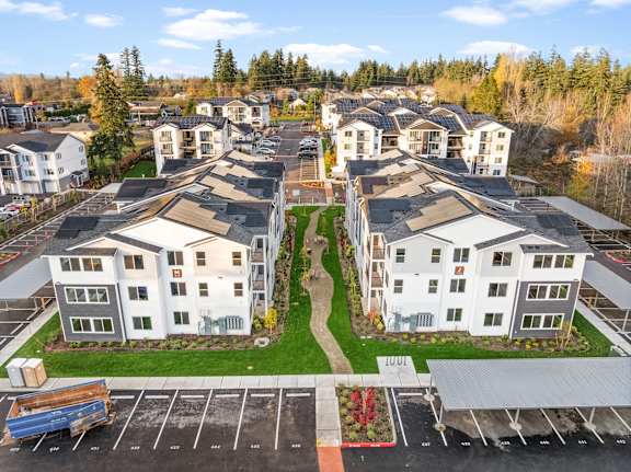 A parking lot in front of apartment buildings.