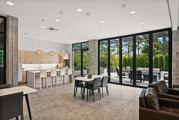 A modern dining room with a table set for six.