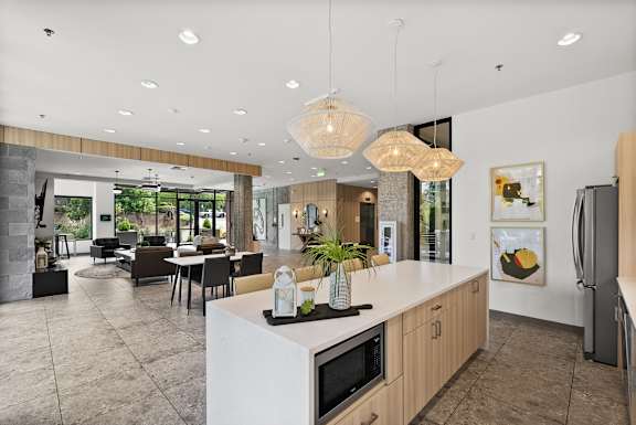 A modern kitchen with a white island and wooden cabinets.