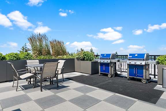 A patio with a table and chairs and a blue and white machine.