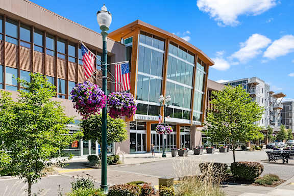 A street view of a building with a flag pole in front of it.