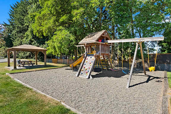 A playground with a swing set and a slide.