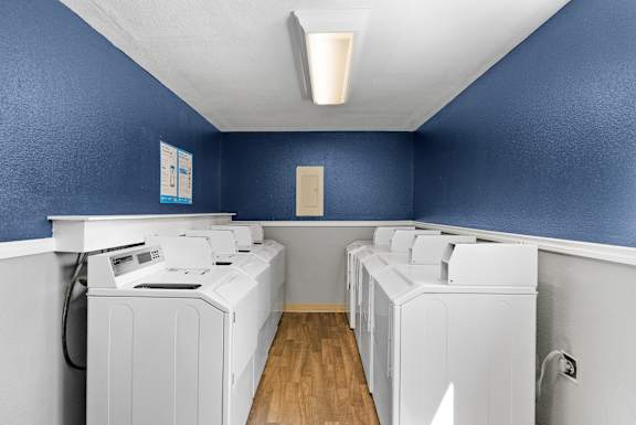 A row of washing machines in a laundromat.
