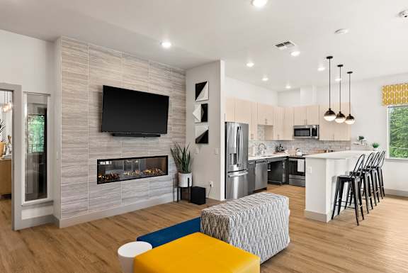 A modern kitchen with a fireplace and a TV above it.
