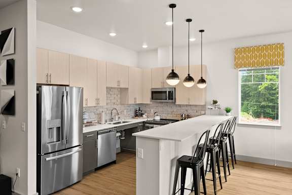 A modern kitchen with a large island and stainless steel appliances.