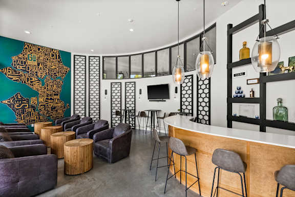 A bar area with a green wall map and a white counter.