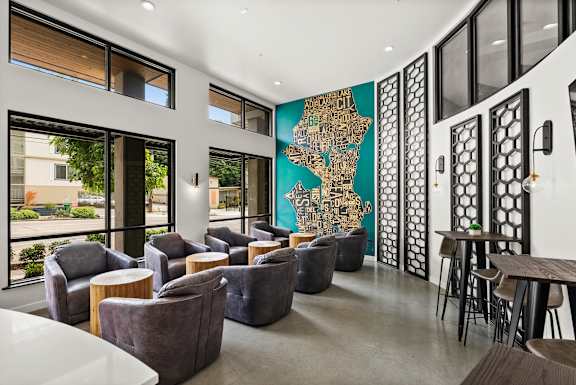 A room with a large map on the wall and a table with chairs.
