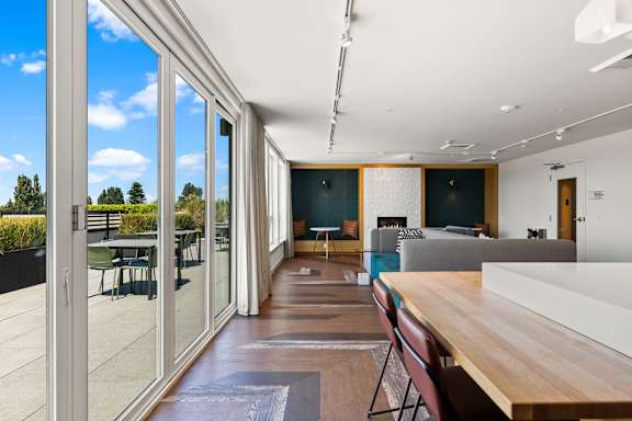 A modern interior with a long wooden table and chairs.