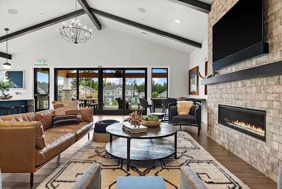 A modern living room with a fireplace and a large window.