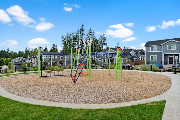A playground with a swing set and a slide.