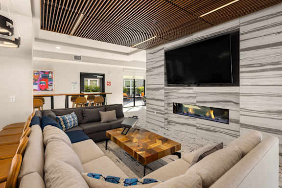 A modern living room with a fireplace and a flat screen TV.