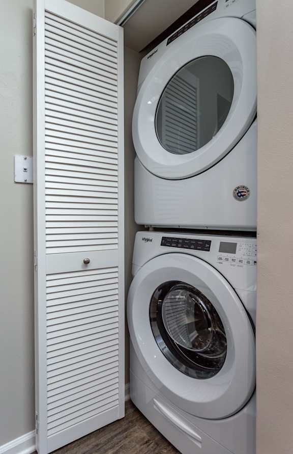 A white washing machine and dryer in a small laundry room.