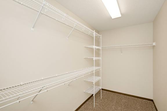 Empty white shelving in a room.