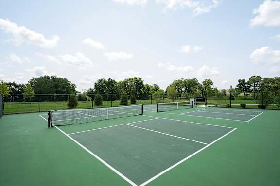 A tennis court with white lines and a net.