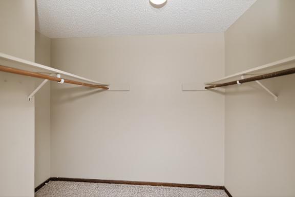 A small, empty room with two shelves.