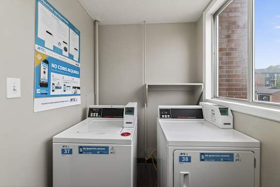 Two ATM machines are in a room with a sign that says "NO COINS REQUIRED".