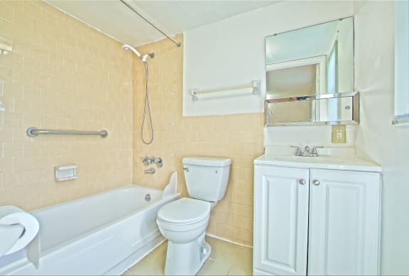 a bathroom with a sink toilet and a bath tub