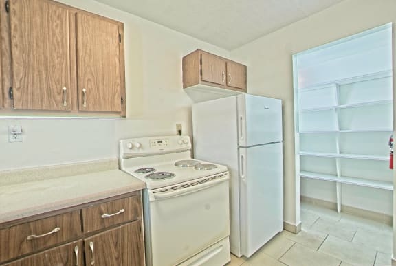 a kitchen with a stove and a refrigerator