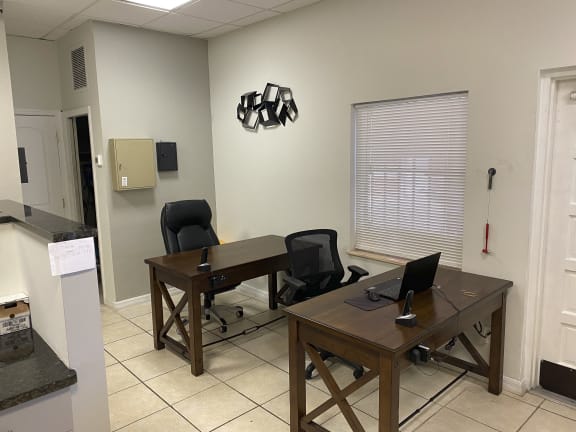 an office with two desks and two chairs
