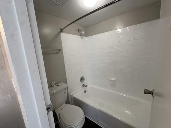 A white bathroom with a toilet, sink, and bathtub.at Auburn Glen Apartments, Jacksonville