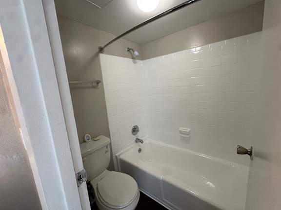 A white bathroom with a toilet, sink, and bathtub.at Auburn Glen Apartments, Jacksonville
