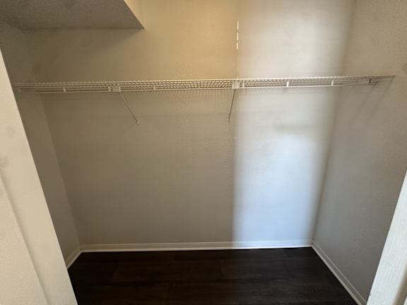 Empty room with a white shelf and dark wood floor.at Auburn Glen Apartments, Jacksonville
