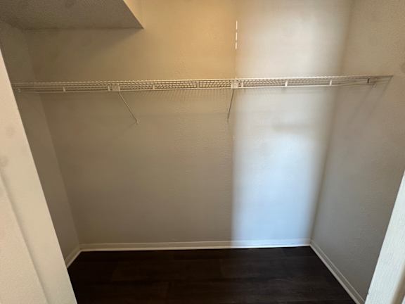 Empty room with a white shelf and dark wood floor.at Auburn Glen Apartments, Jacksonville