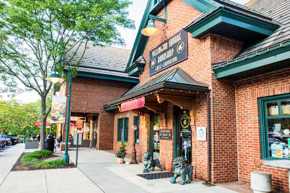 A brick building with a green awning and a sign that says