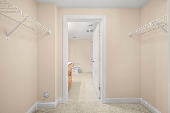 A white doorway leads to a bathroom.