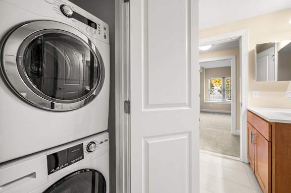 A modern washing machine is placed in a laundry room.