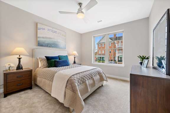 A bedroom with a large bed and a painting on the wall.