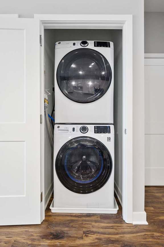 A white washing machine is in a cabinet.