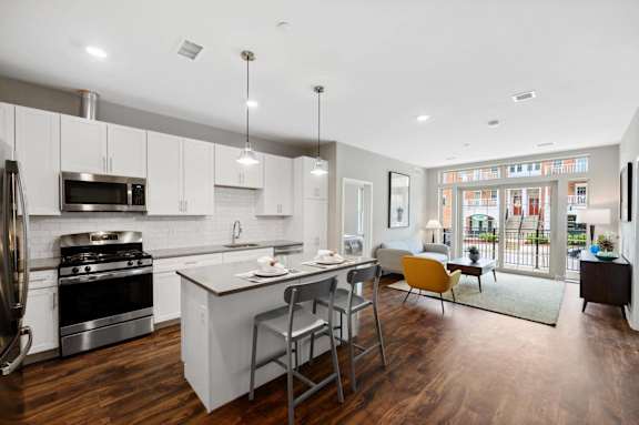 an open kitchen and living room with a table and chairs