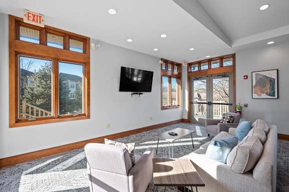 A living room with a couch, chair, and television.
