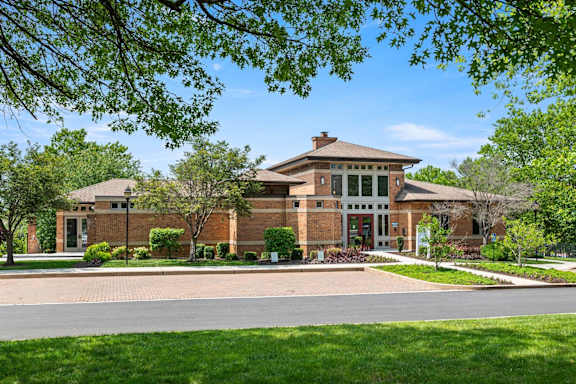 A house with a brick facade and a large front porch.