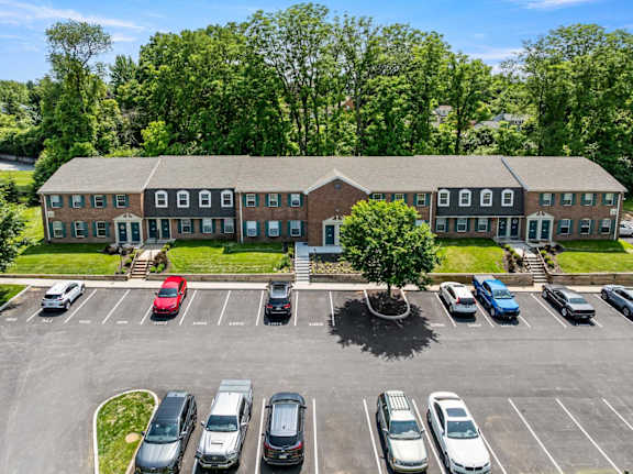 A parking lot with cars and a building in the background.