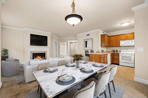 A modern dining room with a marble table and grey chairs.