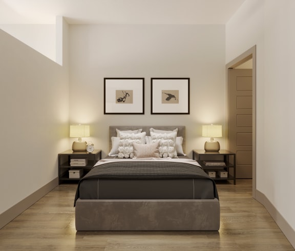a bedroom with a bed and two pictures on the wall at Bemiston Place Apartments, Missouri